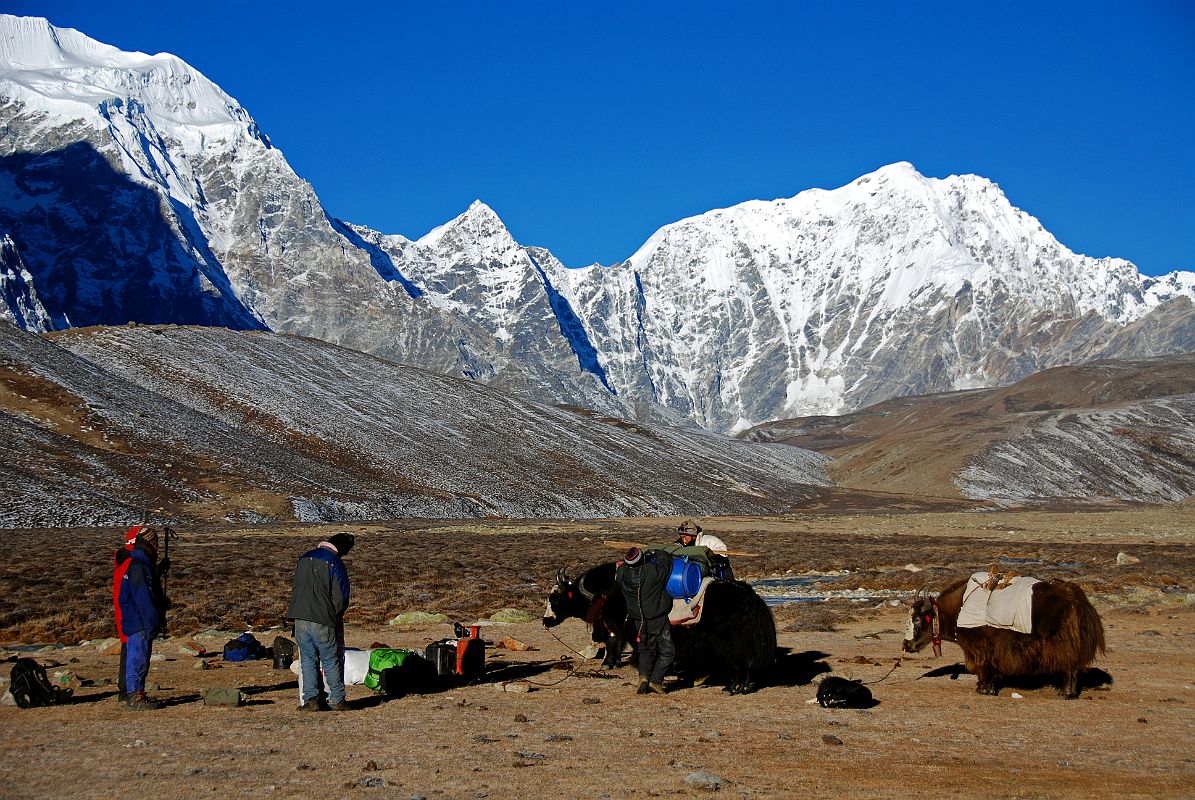 02 Loading The Yaks With Gur Karpo Ri And Pemthang Ri At Valley Junction To Kong Tso Above Drakpochen Our yak herders load the yaks as we prepare to leave camp.